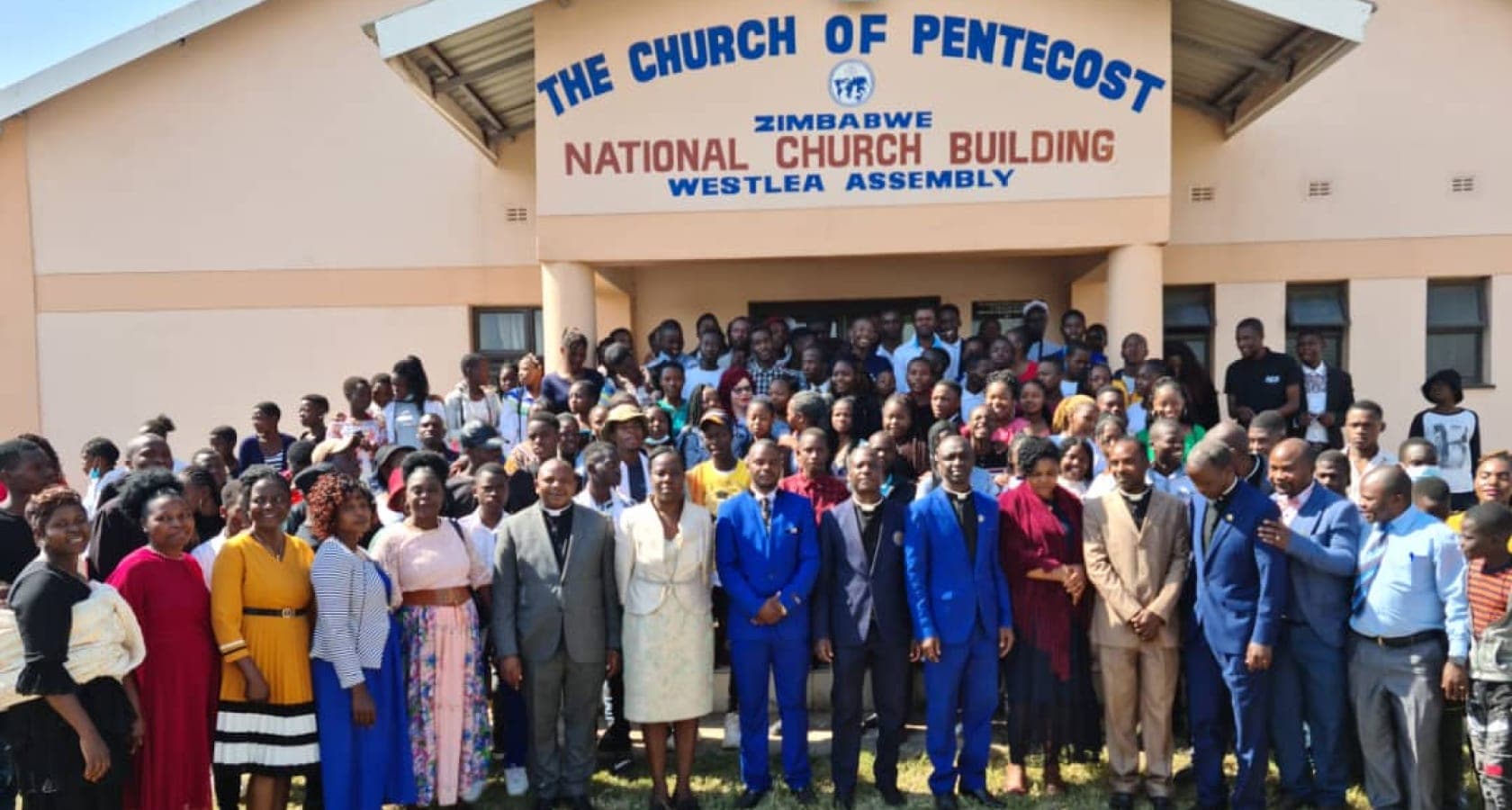 Members and ministers gathered outside the National Church Building, Westlea Assembly